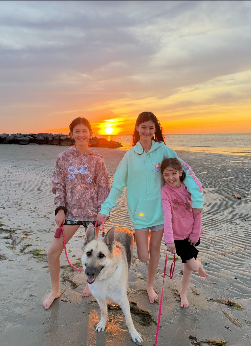 Girls and MaeMae at Beach Bennett and sisters at the beach with dog